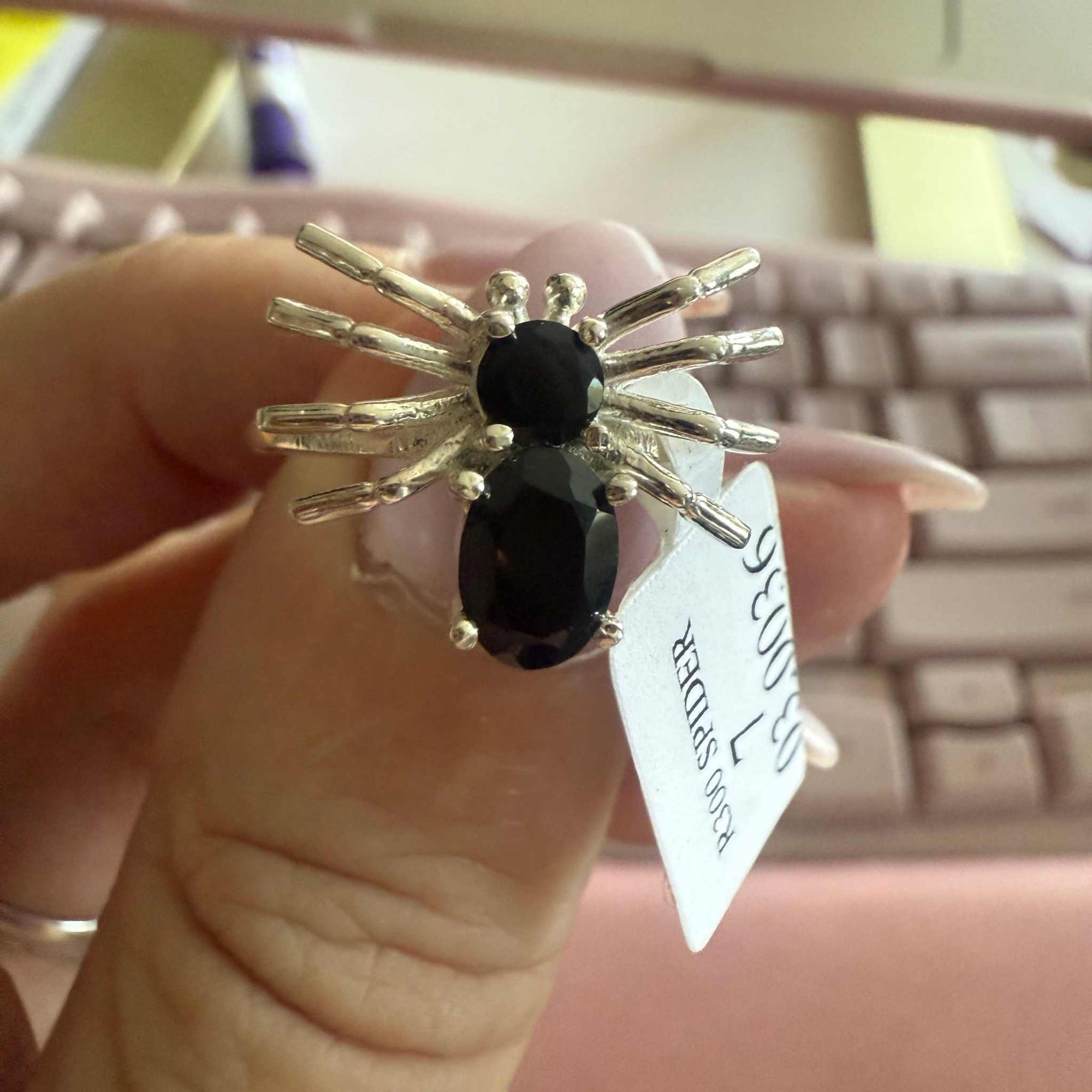 Spider ring with precious metal band and spider legs with gemstone spider body