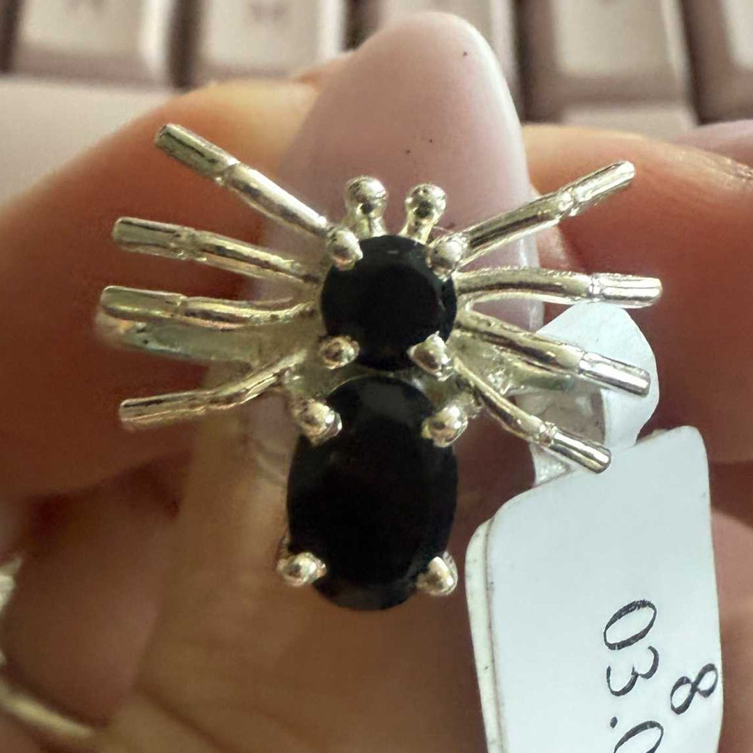 Spider ring with precious metal band and spider legs with gemstone spider body