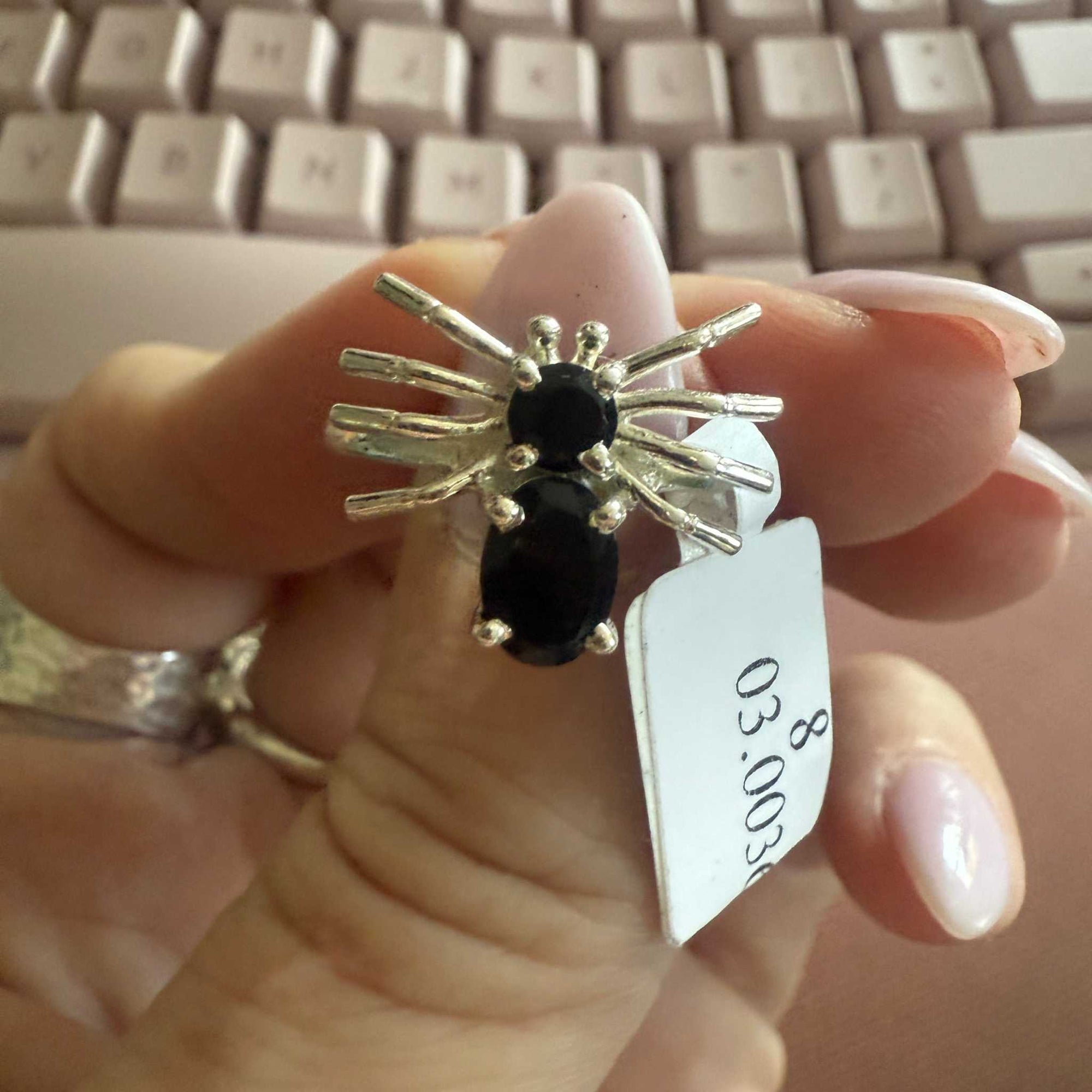 Spider ring with precious metal band and spider legs with gemstone spider body