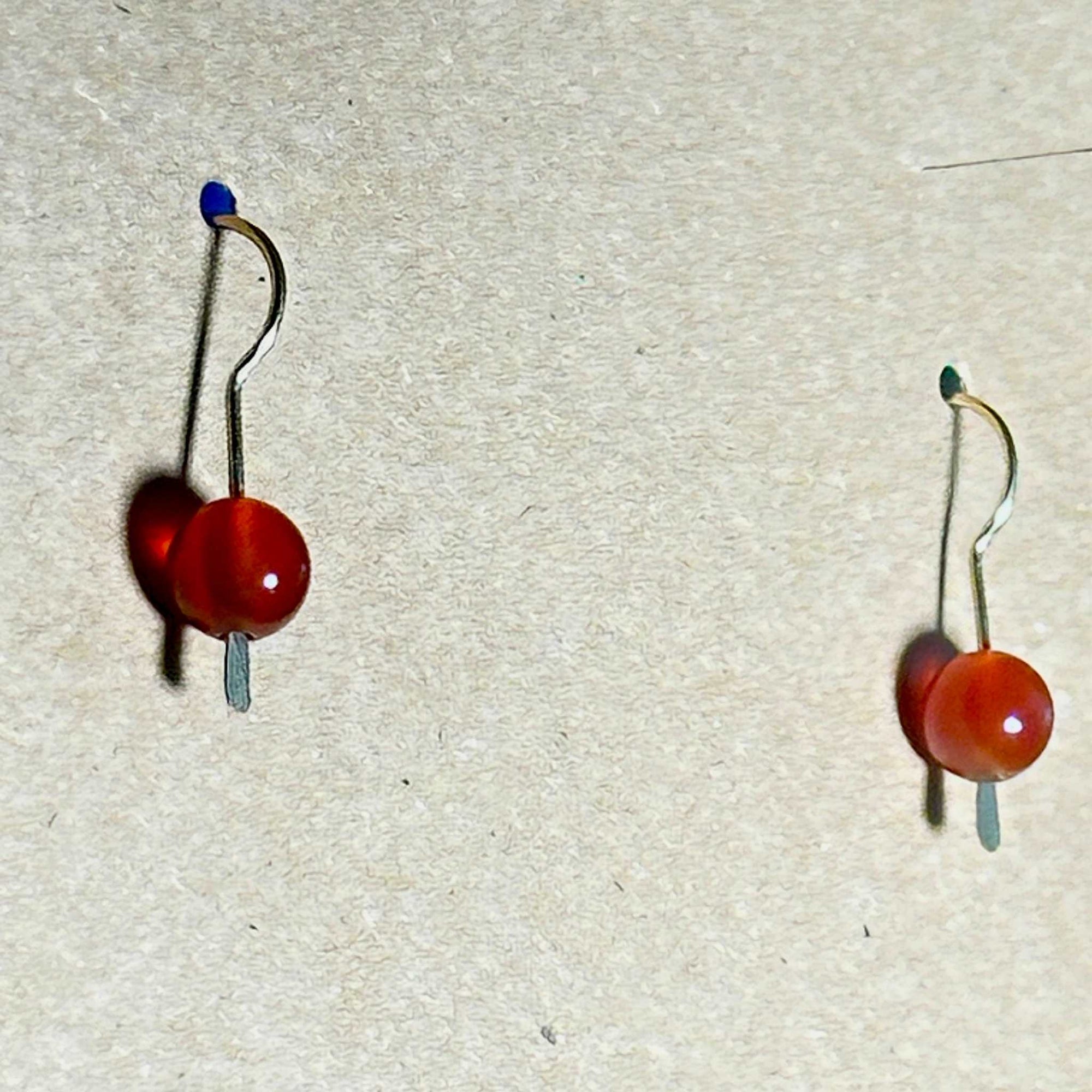 Pair of earrings with red Carnelian stones on a background