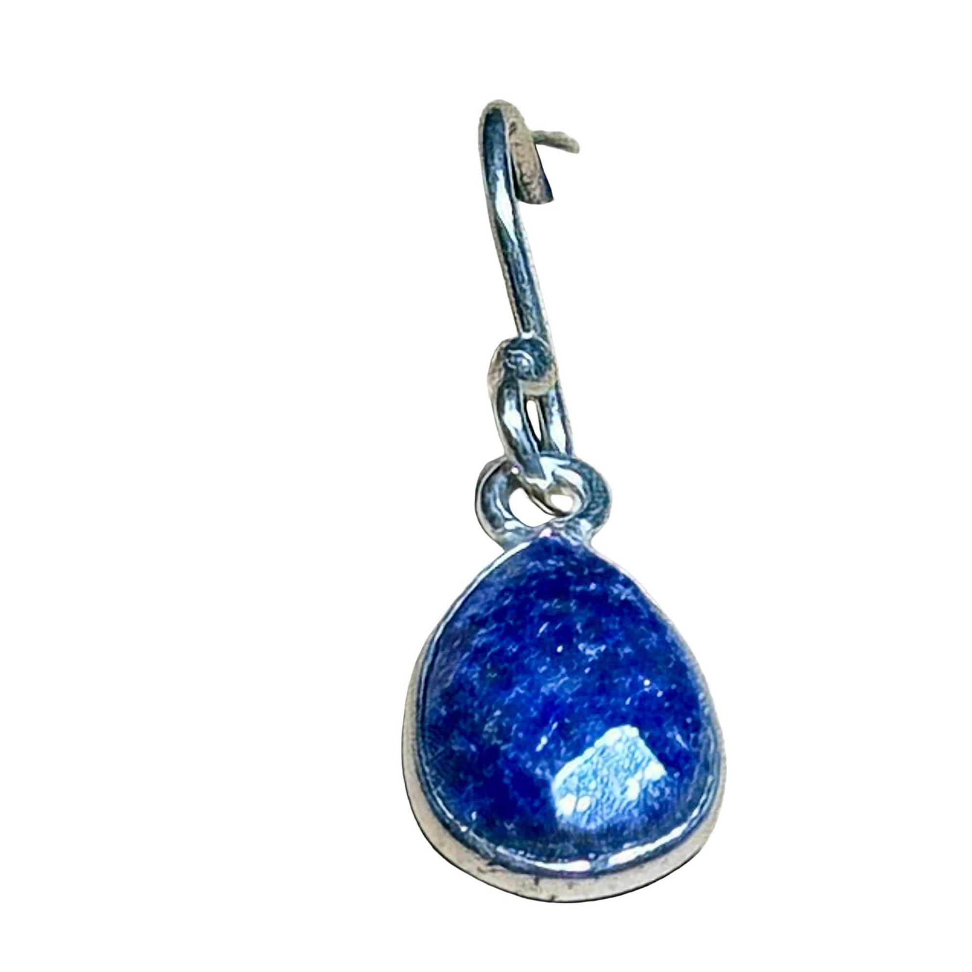 Blue Lapis Lazuli faceted teardrop earring in sterling silver setting on a background