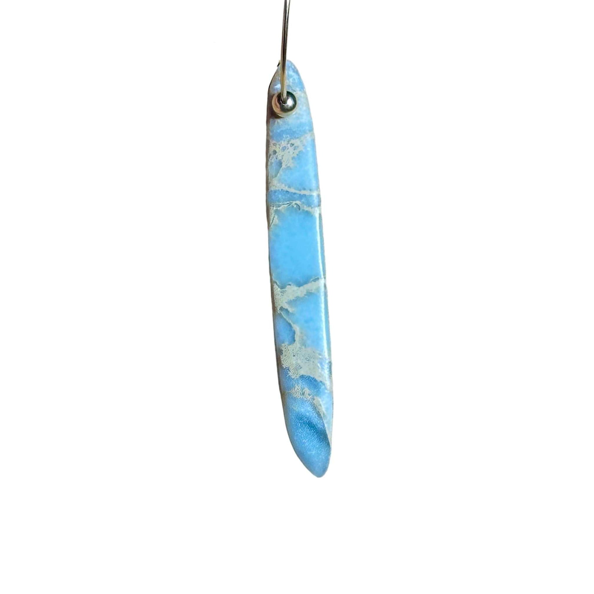 Gold Hoop earrings with blue marbled African Opal stone pendant on a background