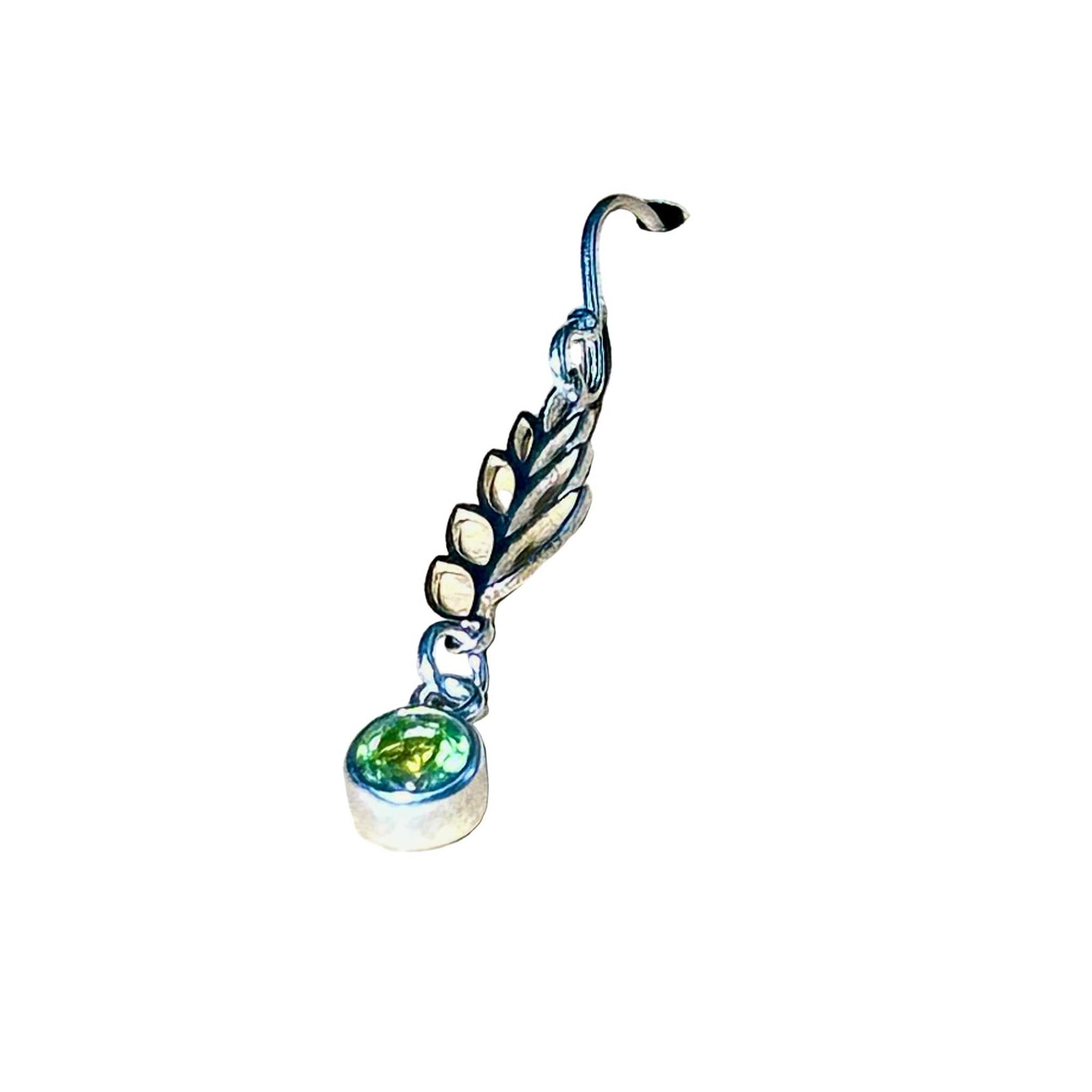 Silver earring with a green Peridot gemstone on a white background