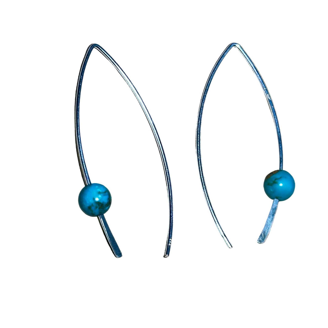 Pair of earrings with turquoise beads on a white background
