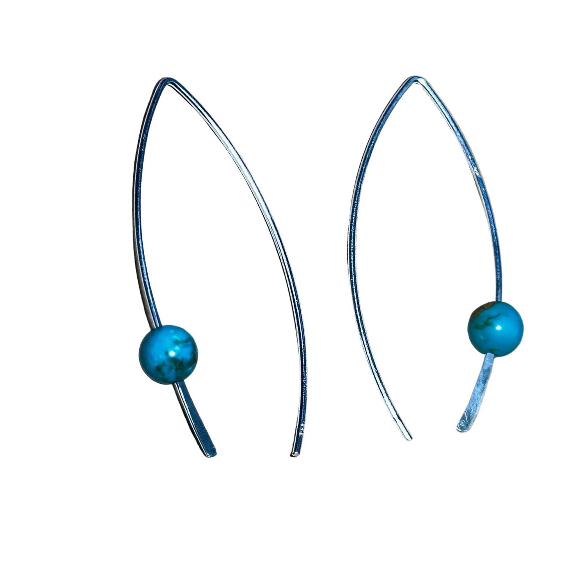 Pair of earrings with turquoise beads on a white background
