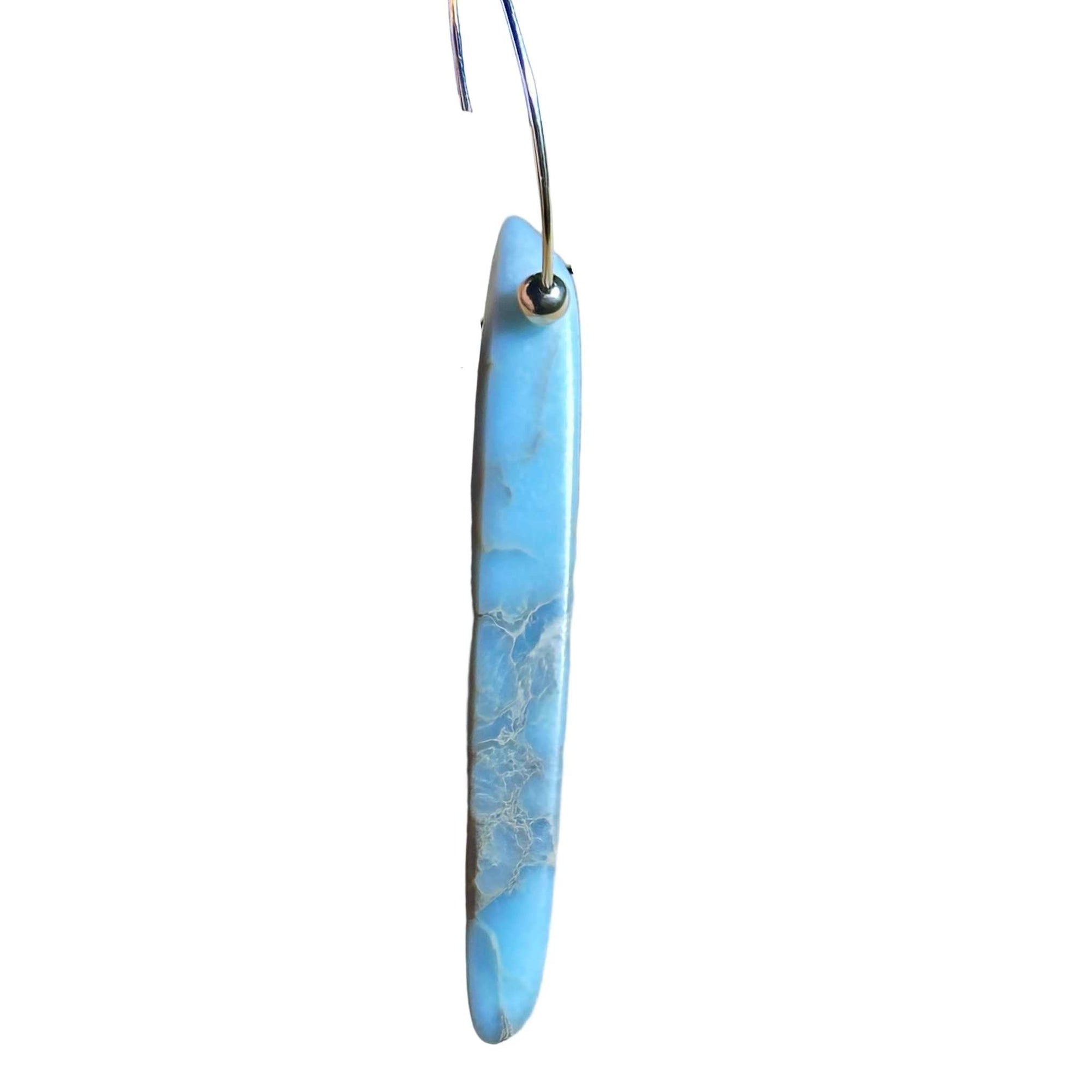 Gold Hoop earring with blue marbled African Opal stone pendant on a background