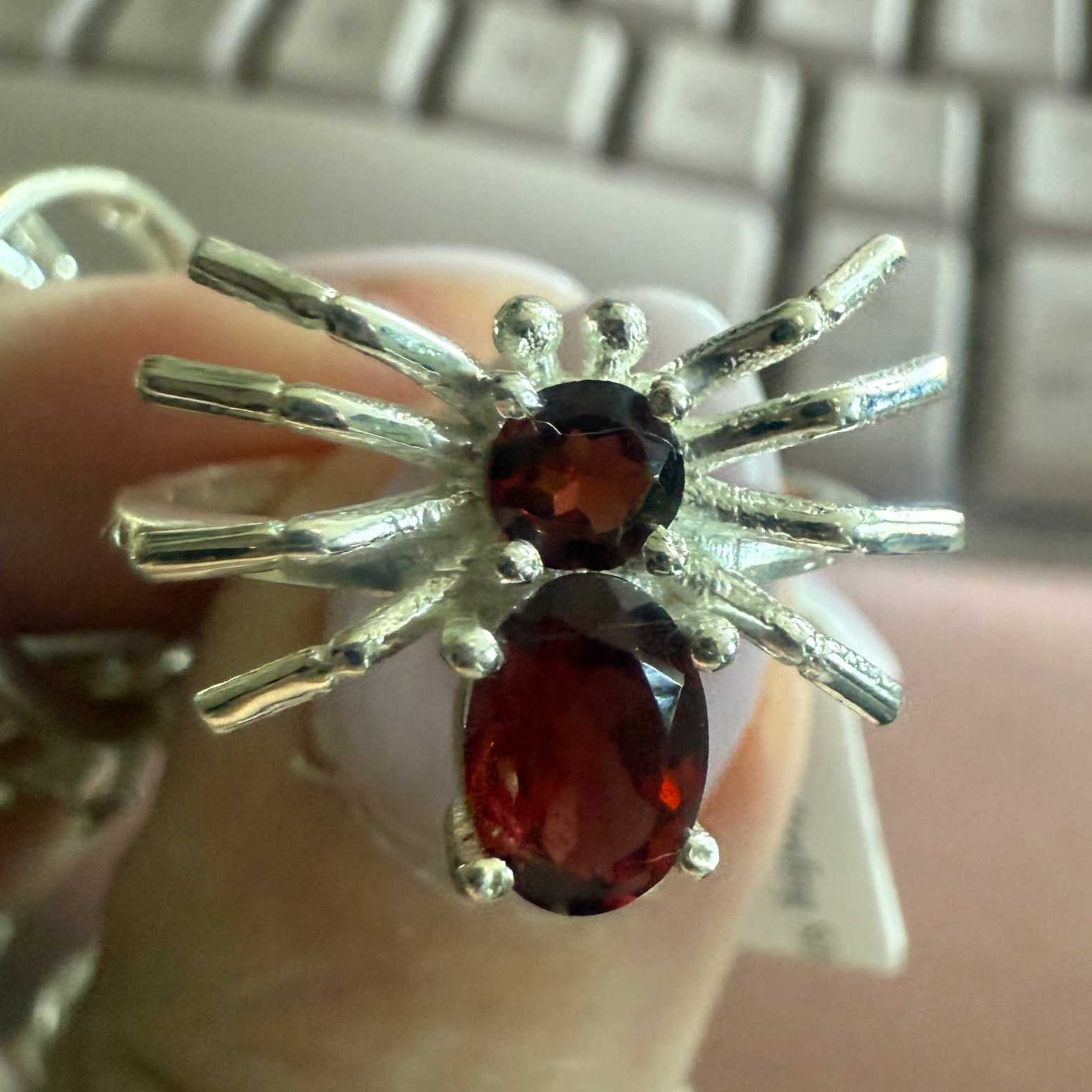 Spider ring with precious metal band and spider legs with gemstone spider body