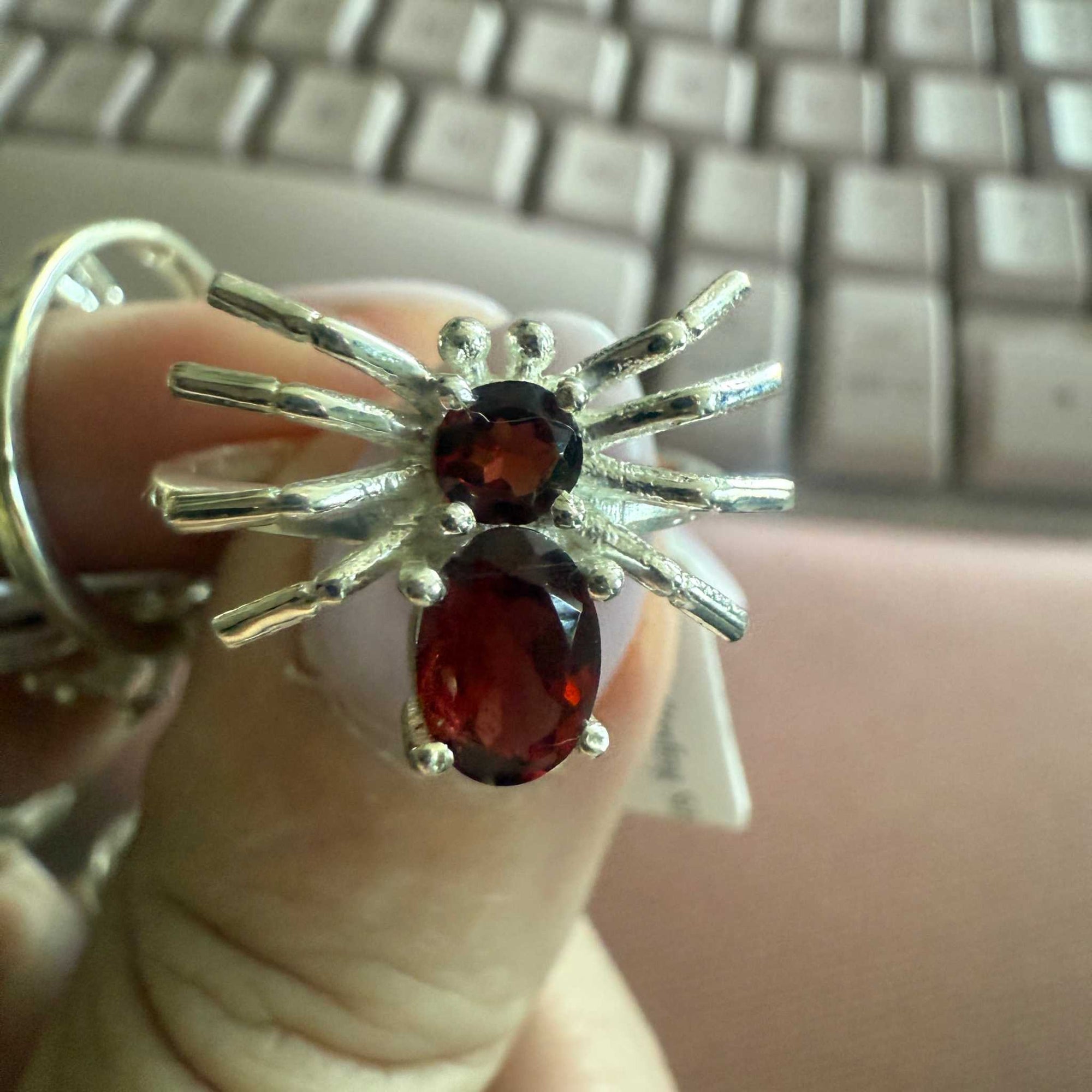 Spider ring with precious metal band and spider legs with gemstone spider body