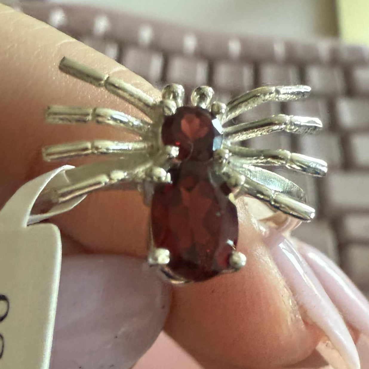 Spider ring with precious metal band and spider legs with gemstone spider body