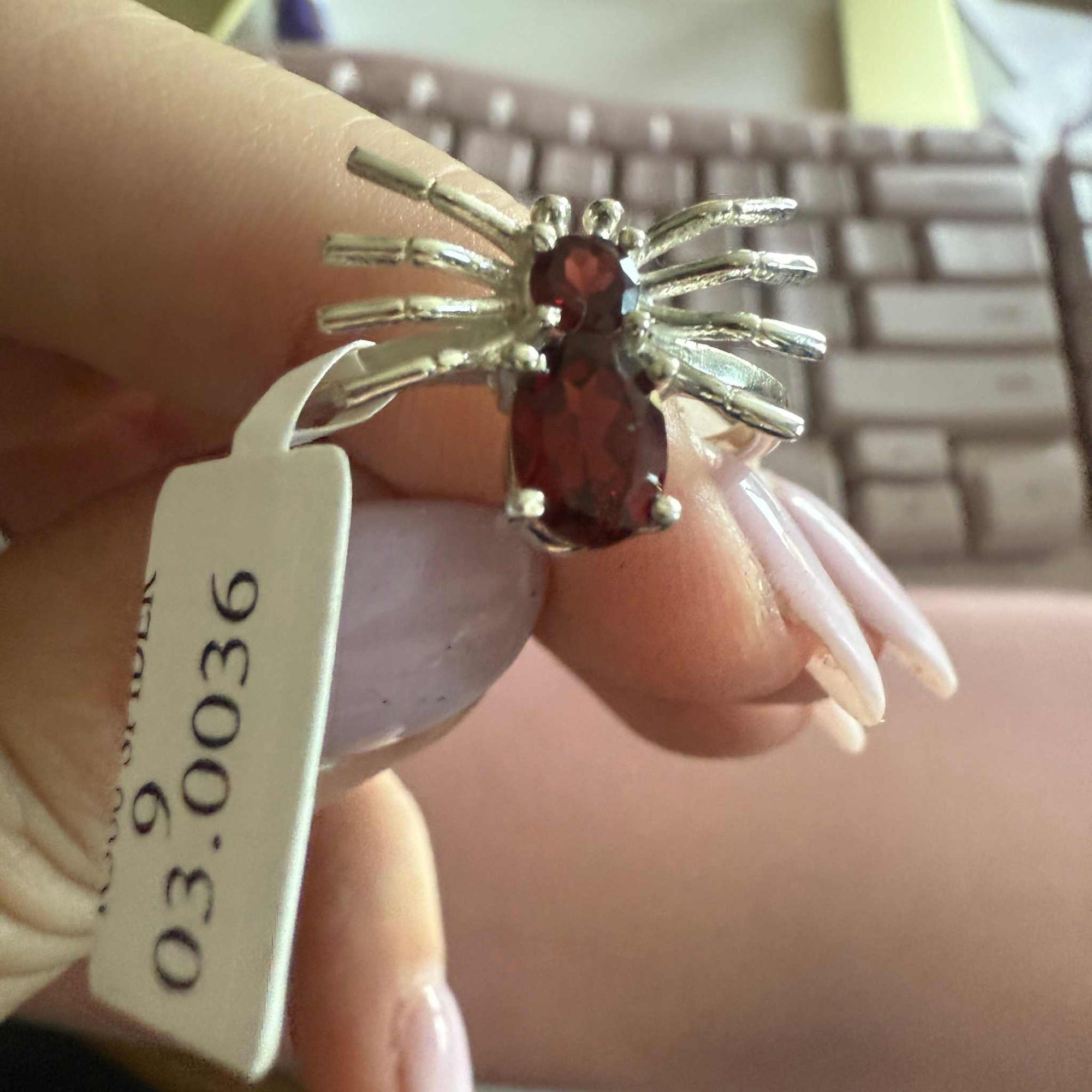 Spider ring with precious metal band and spider legs with gemstone spider body