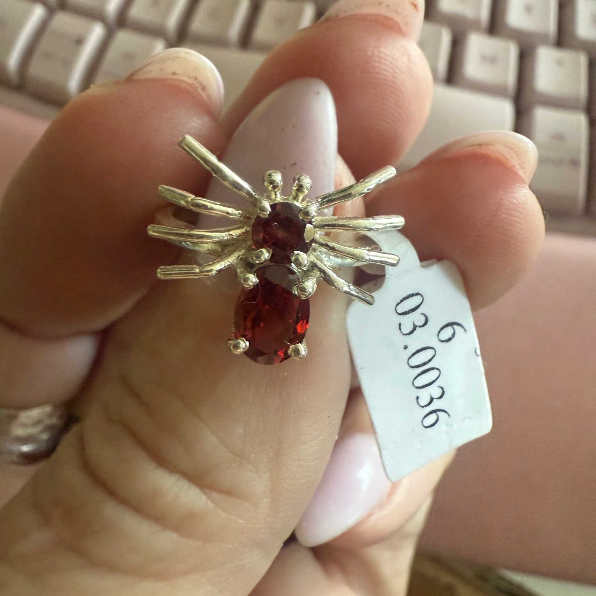 Spider ring with precious metal band and spider legs with gemstone spider body