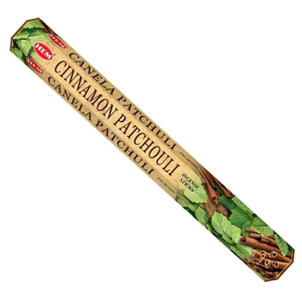 Cinnamon Patchouli incense stick box with cinnamon sticks and leaves on a white background