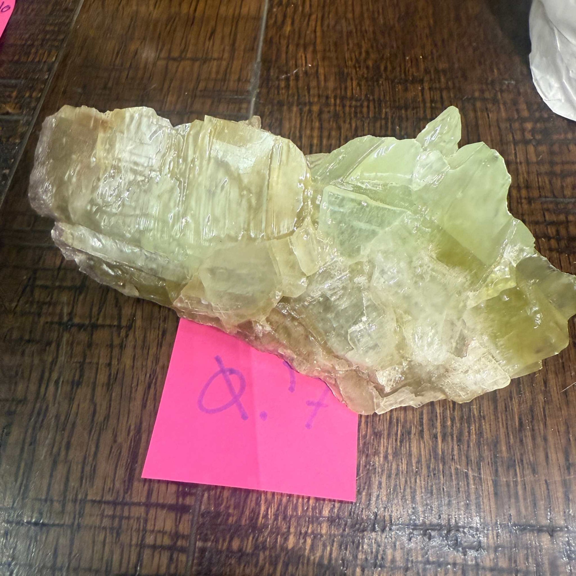 Green Calcite Specimen on wooden surface.