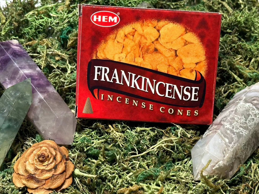 HEM Frankincense Incense Cones with gemstones and dried flower on moss.