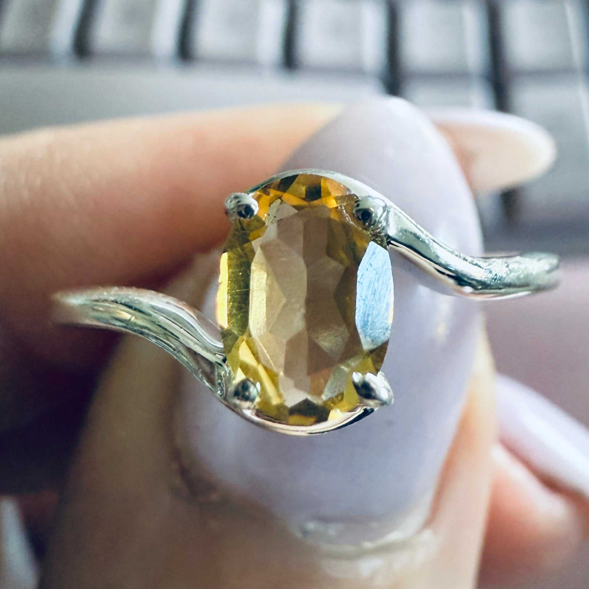 This Citrine Oval Bubble-Band Ring features a faceted golden citrine set between polished silver spheres; Citrine is said to amplify confidence, prosperity, and joy, creating an uplifting everyday piece with a unique, modern design.