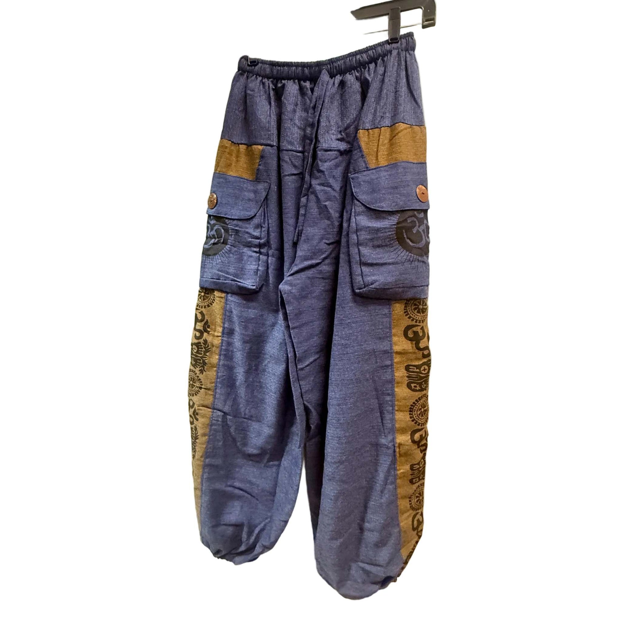Blue pants with patterned side panels hanging on a door