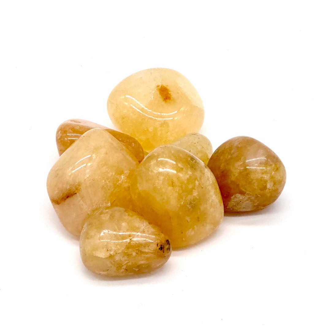 Golden Healer Quartz tumbled stones with radiant golden hues for clarity and spiritual connection.