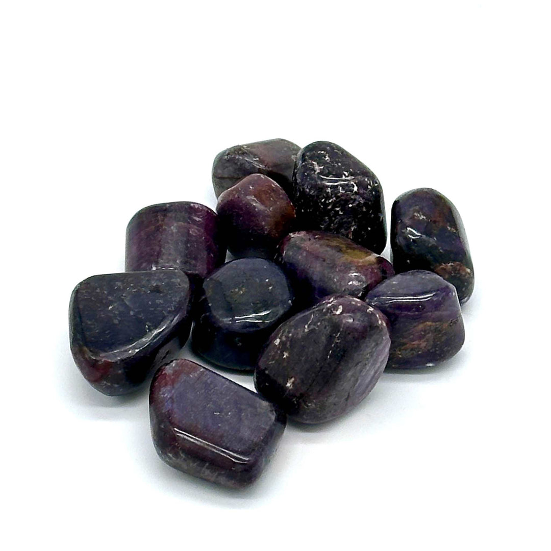 Opaque Star Ruby Corundum gemstones showcasing asterism effect on white background.