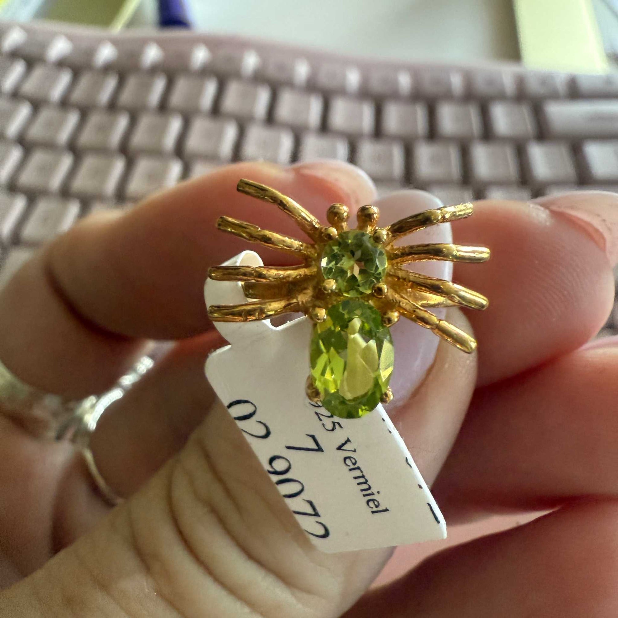 Spider ring with precious metal band and spider legs with gemstone spider body