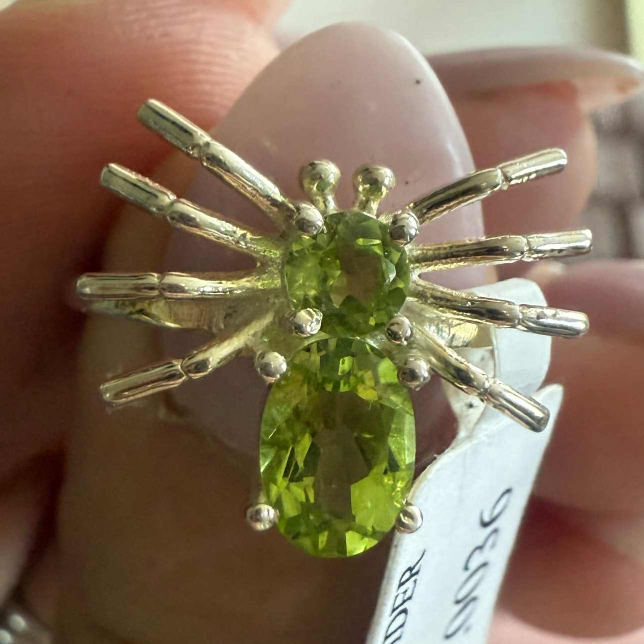 Spider ring with precious metal band and spider legs with gemstone spider body