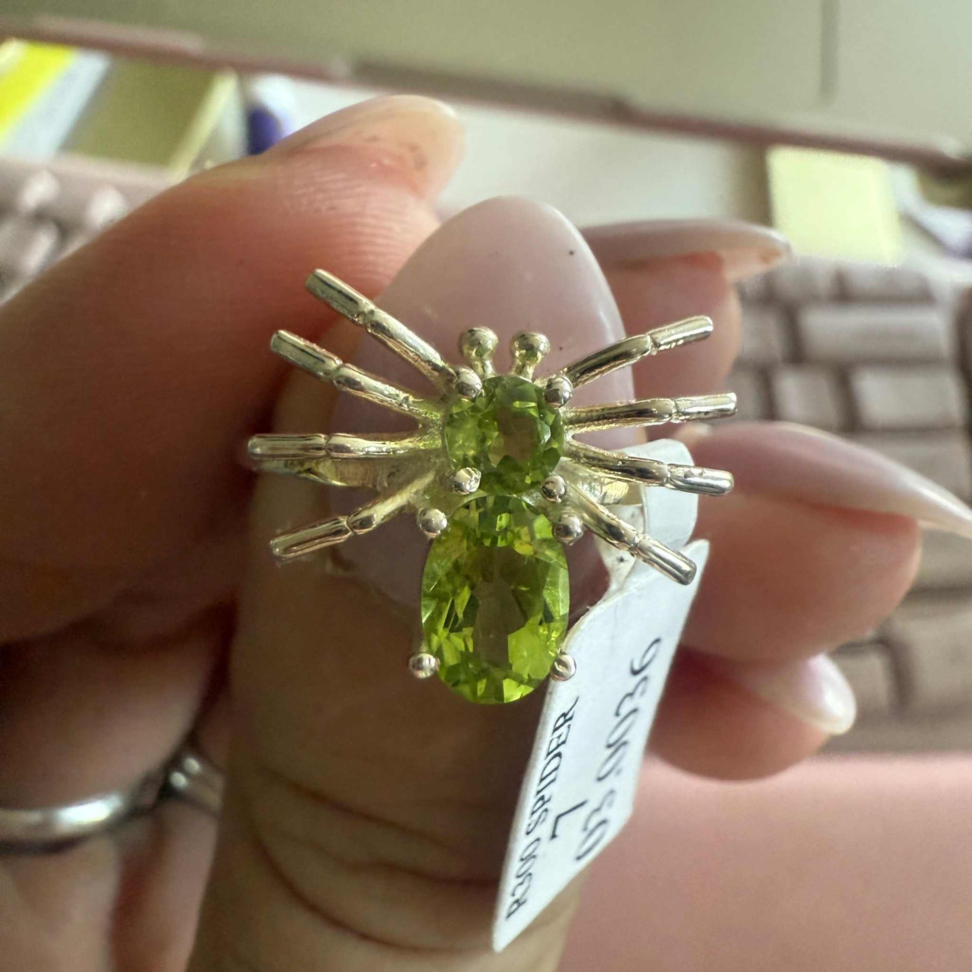 Spider ring with precious metal band and spider legs with gemstone spider body