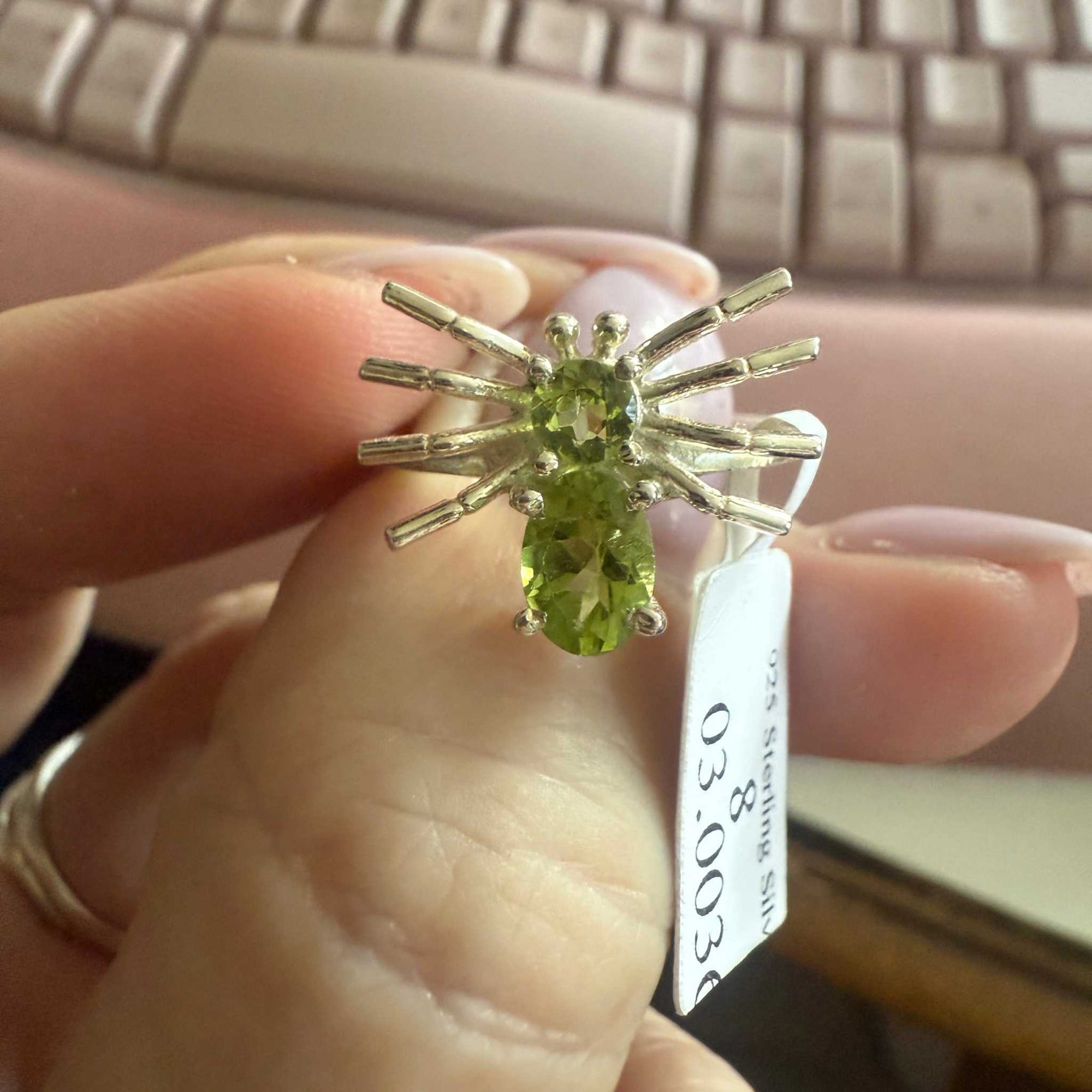 Spider ring with precious metal band and spider legs with gemstone spider body