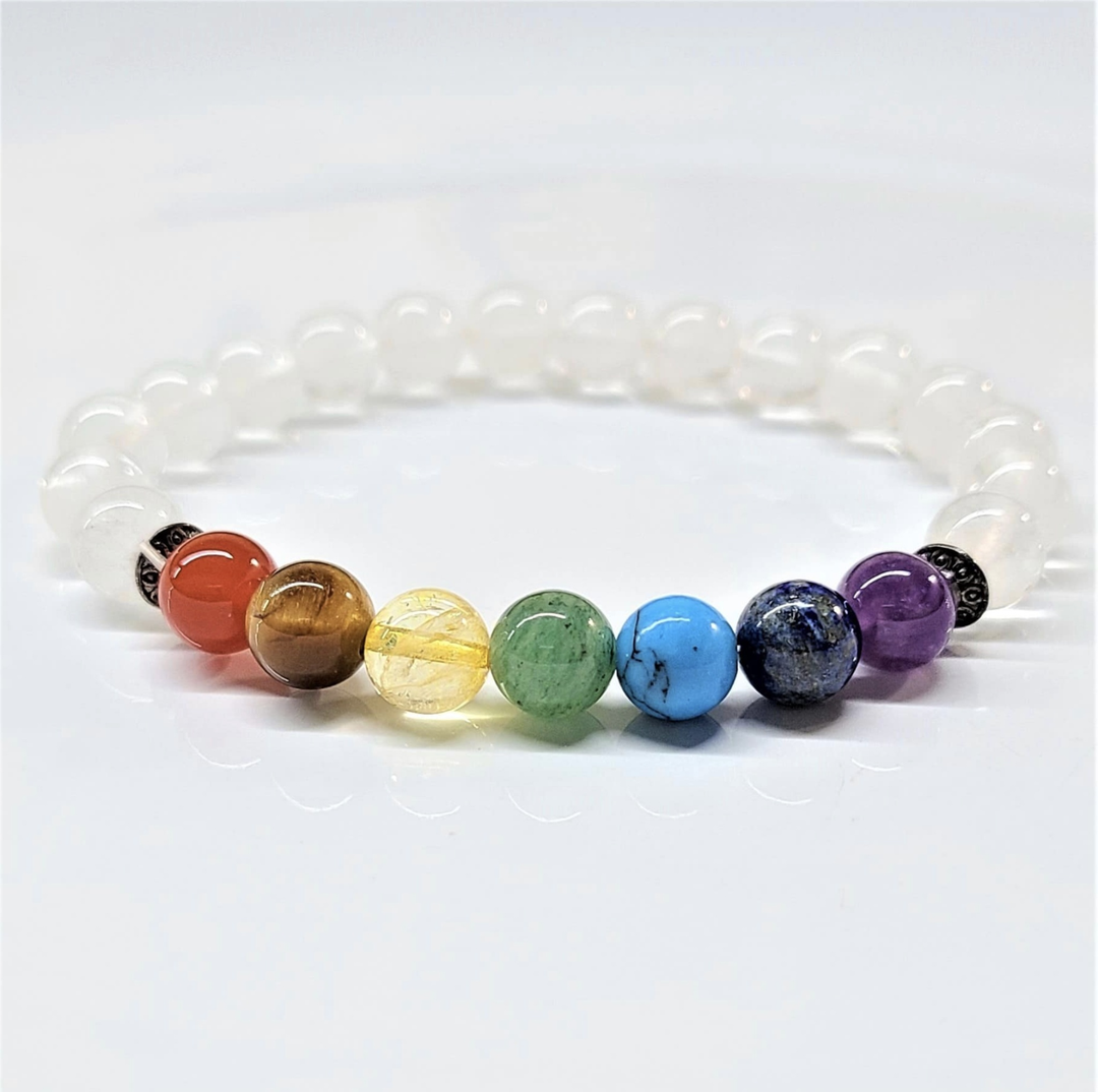 Clear Quartz Chakra Bracelet with 8mm round beads featuring seven colorful chakra stones and white quartz beads for energy balancing.