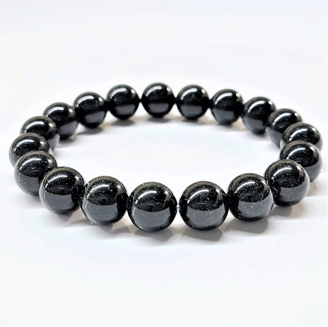 Green Goldstone stackable round bead bracelet with shimmering green beads for healing and abundance