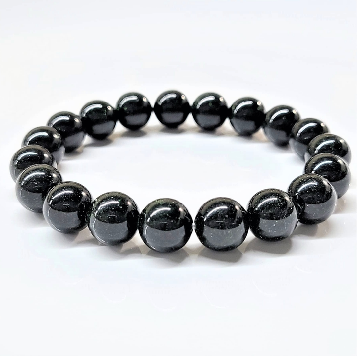 Green Goldstone stackable round bead bracelet with shimmering green beads for healing and abundance