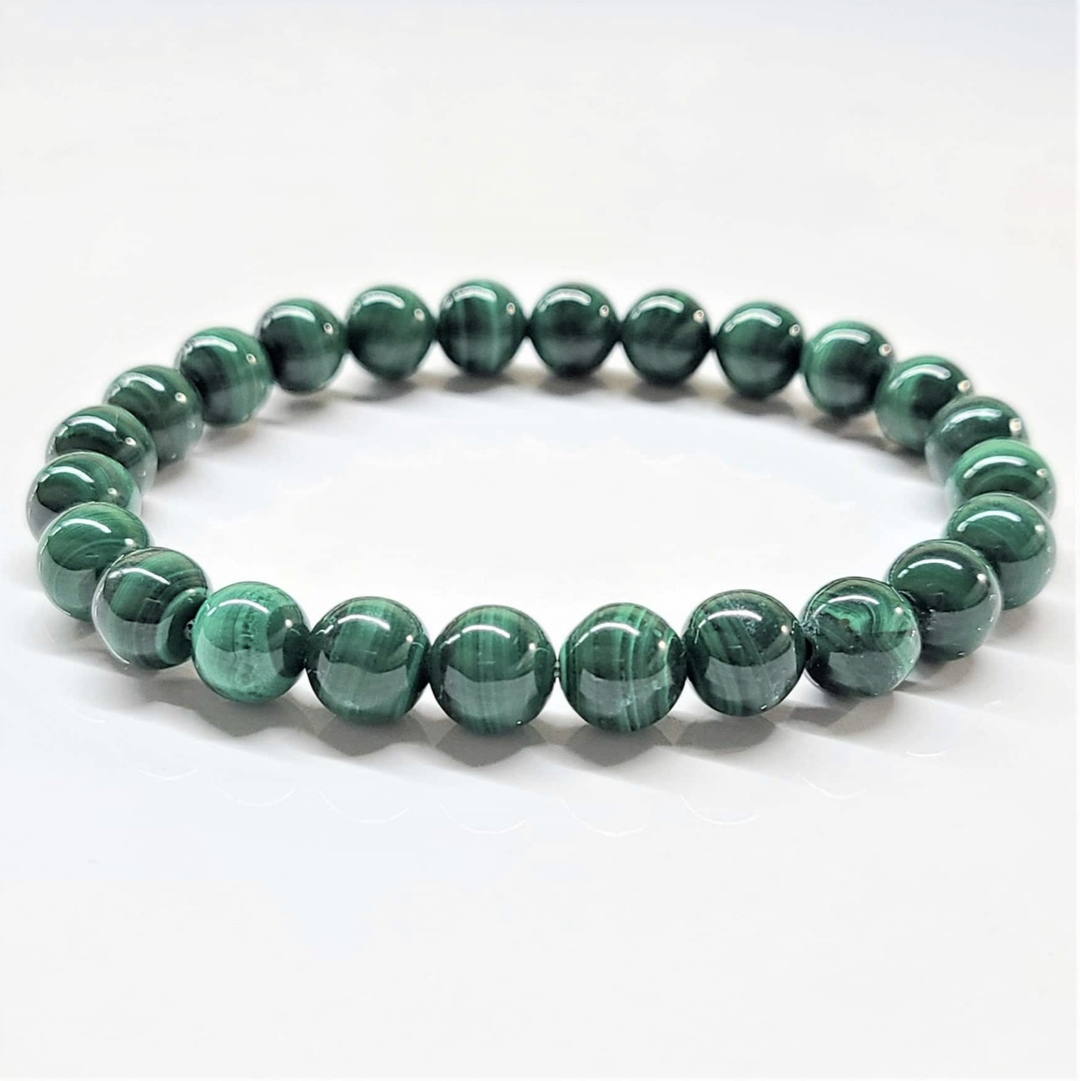 Natural Malachite stackable bracelet with polished green gemstone beads showing characteristic banding patterns