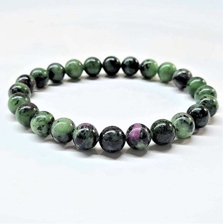 Ruby Zoisite stackable bracelet with round green and pink gemstone beads, adjustable fit, promoting emotional balance and spiritual growth.