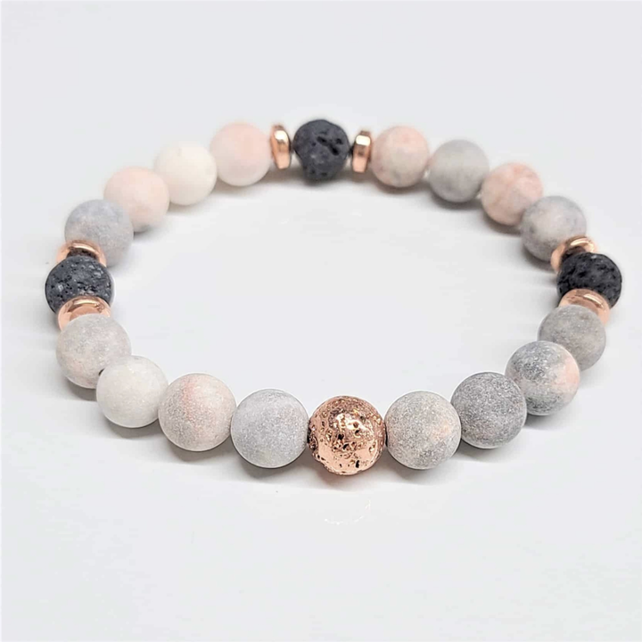 Pink Zebra Jasper stackable bracelet with 8mm round beads and lava stone accents for grounding and emotional balance