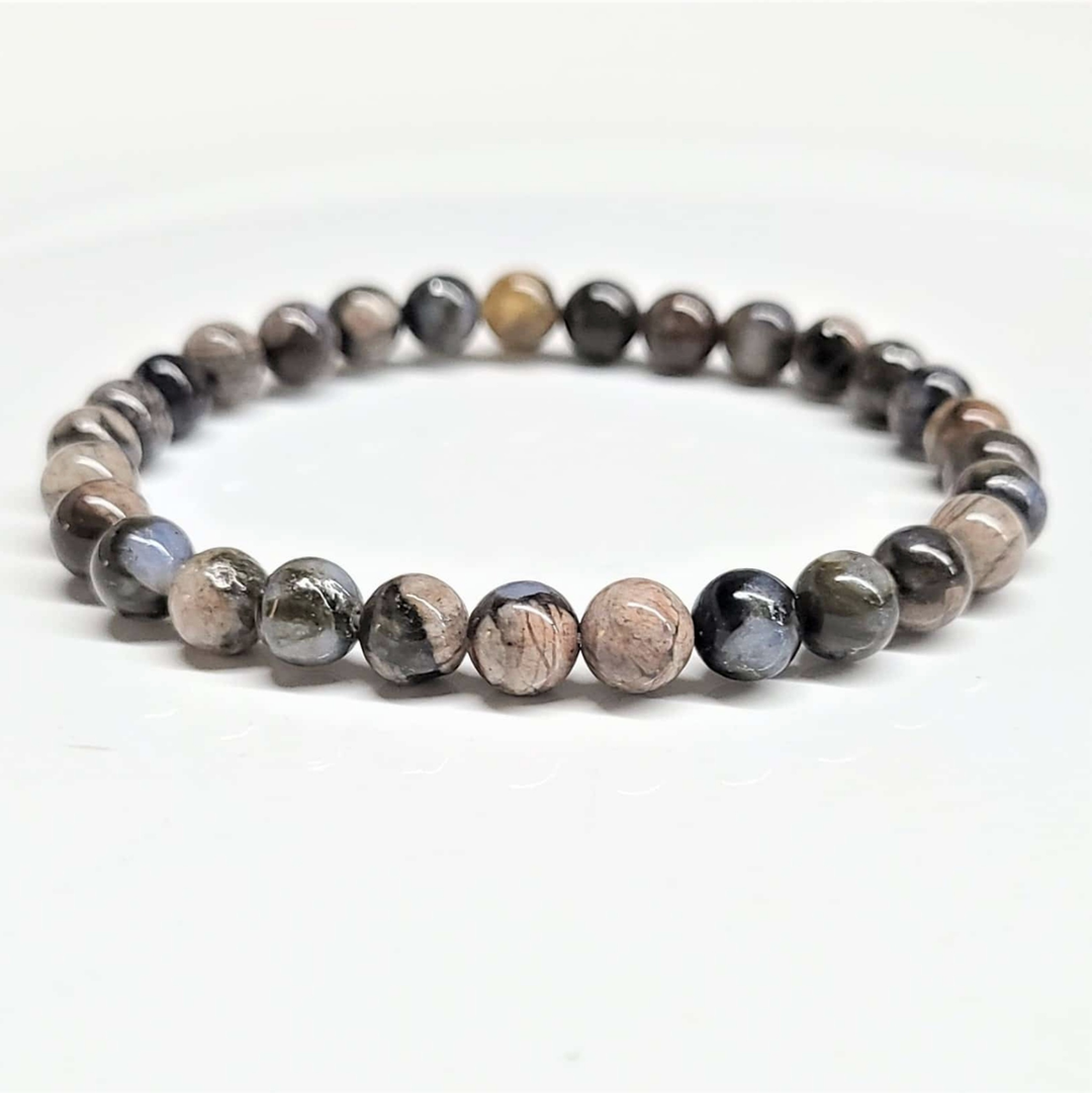 Que Sera round bead stackable bracelet featuring multi-colored speckled natural stones.