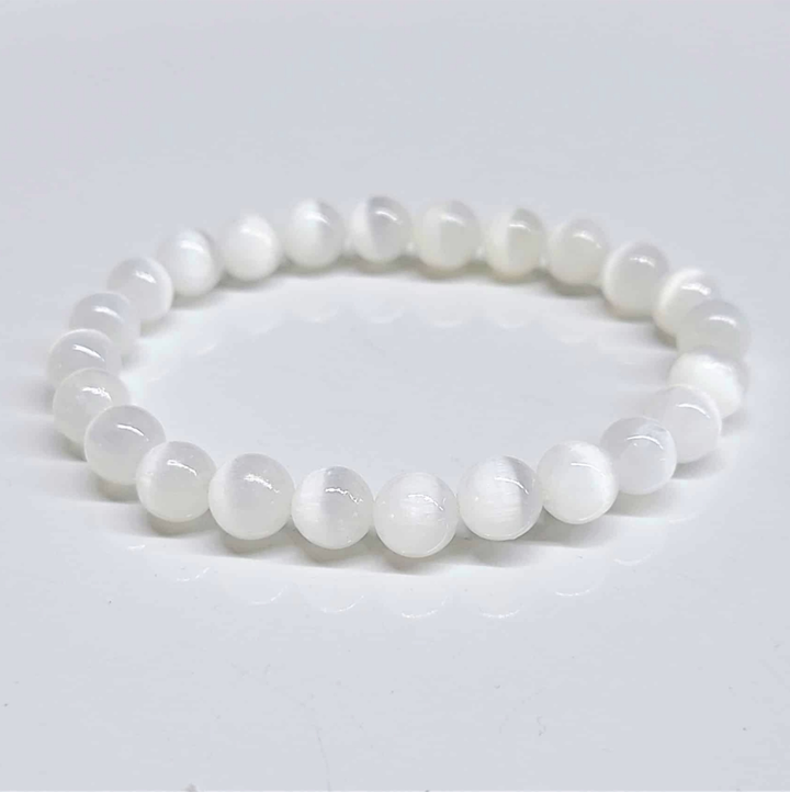 Selenite stackable bracelet with smooth 8mm round beads for aura cleansing and spiritual energy.