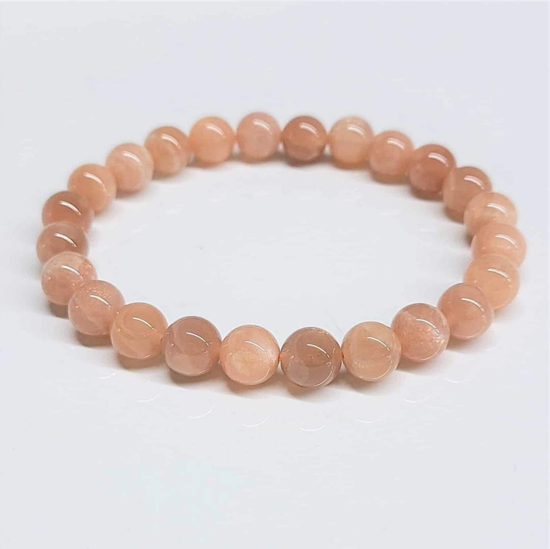 Sunstone round bead stackable bracelet with polished peach-orange crystals for optimistic energy and positivity.