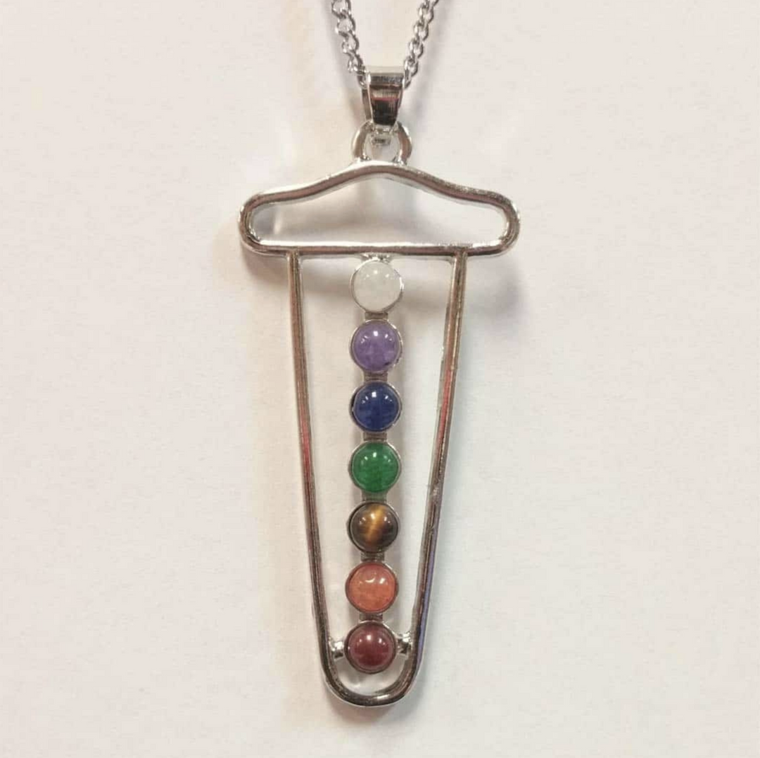 Chakra necklace with seven colorful stones and a modern pendant design.