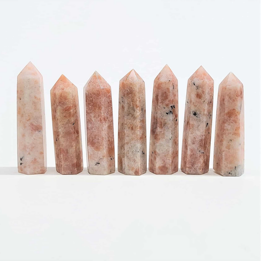 Sunstone Destiny Tower crystals with vibrant shimmer, known for joy and positivity metaphysical properties.