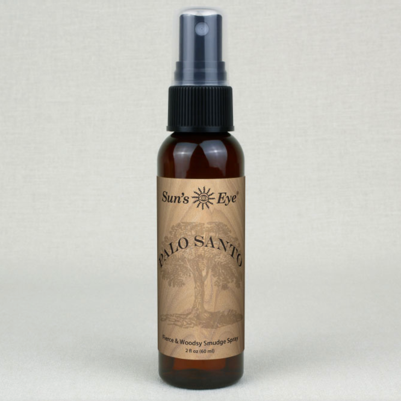 Palo Santo Clearing Spray 2 oz in brown bottle with black spray top for cleansing and meditation