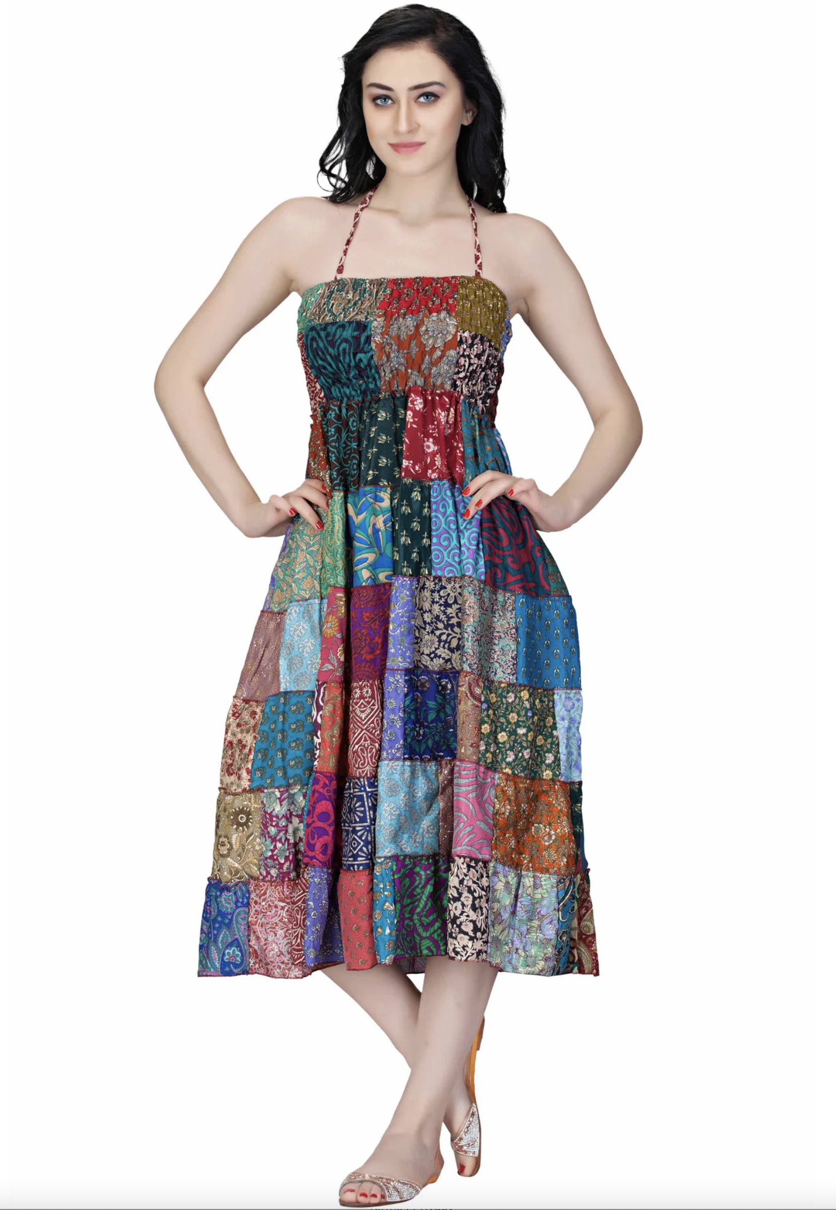 Woman wearing a colorful patchwork short sari dress with halter neckline and knee-length hem
