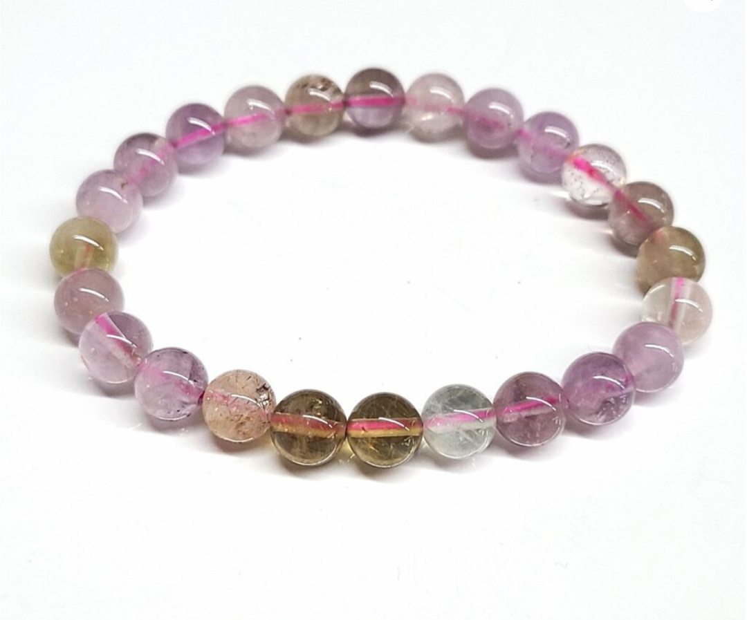 Auralite 23 stackable bracelet with 8mm purple and brown beads.
