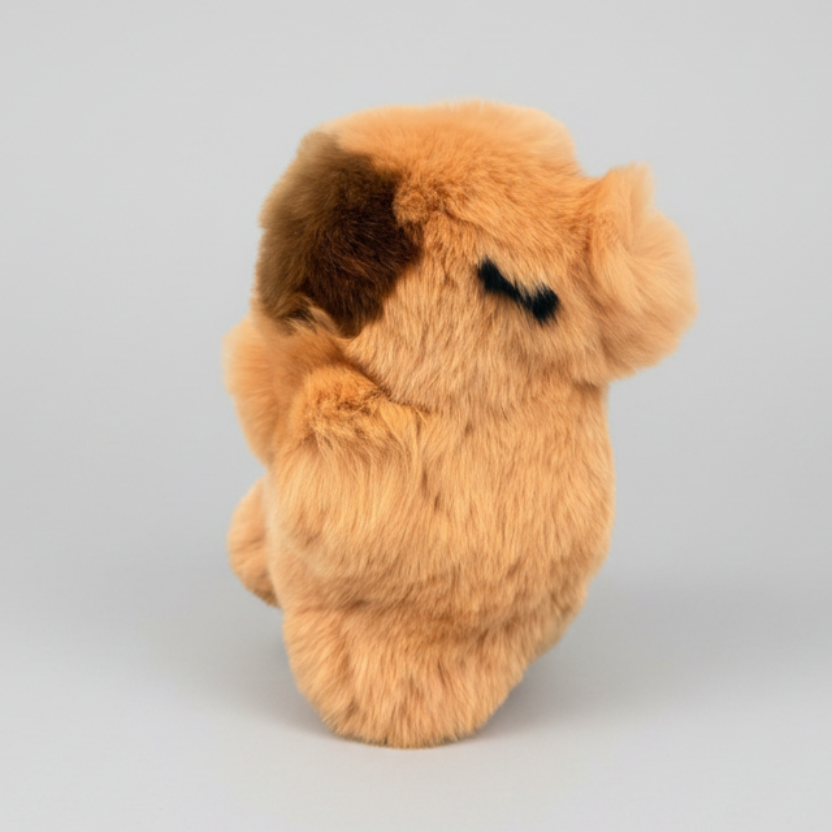 Plush toy resembling a dog with brown fur on a white background