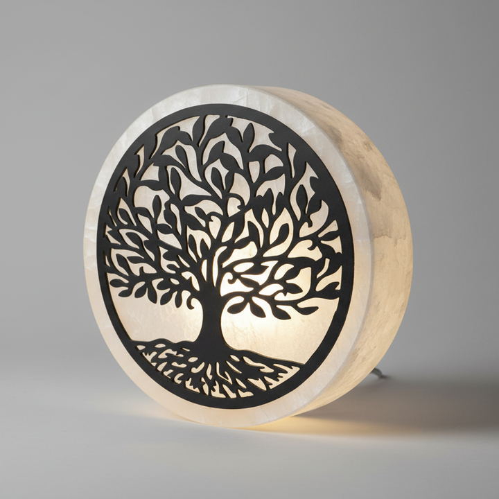 Round wooden light with tree of life design on a gray background