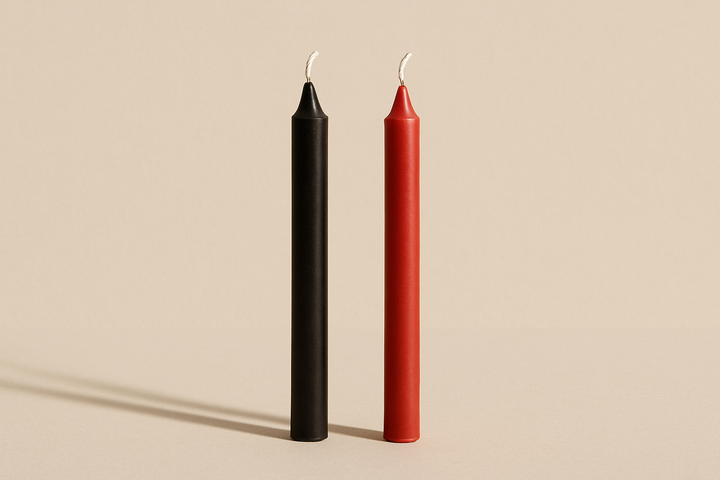 a black and a red chime candleon a nutral background