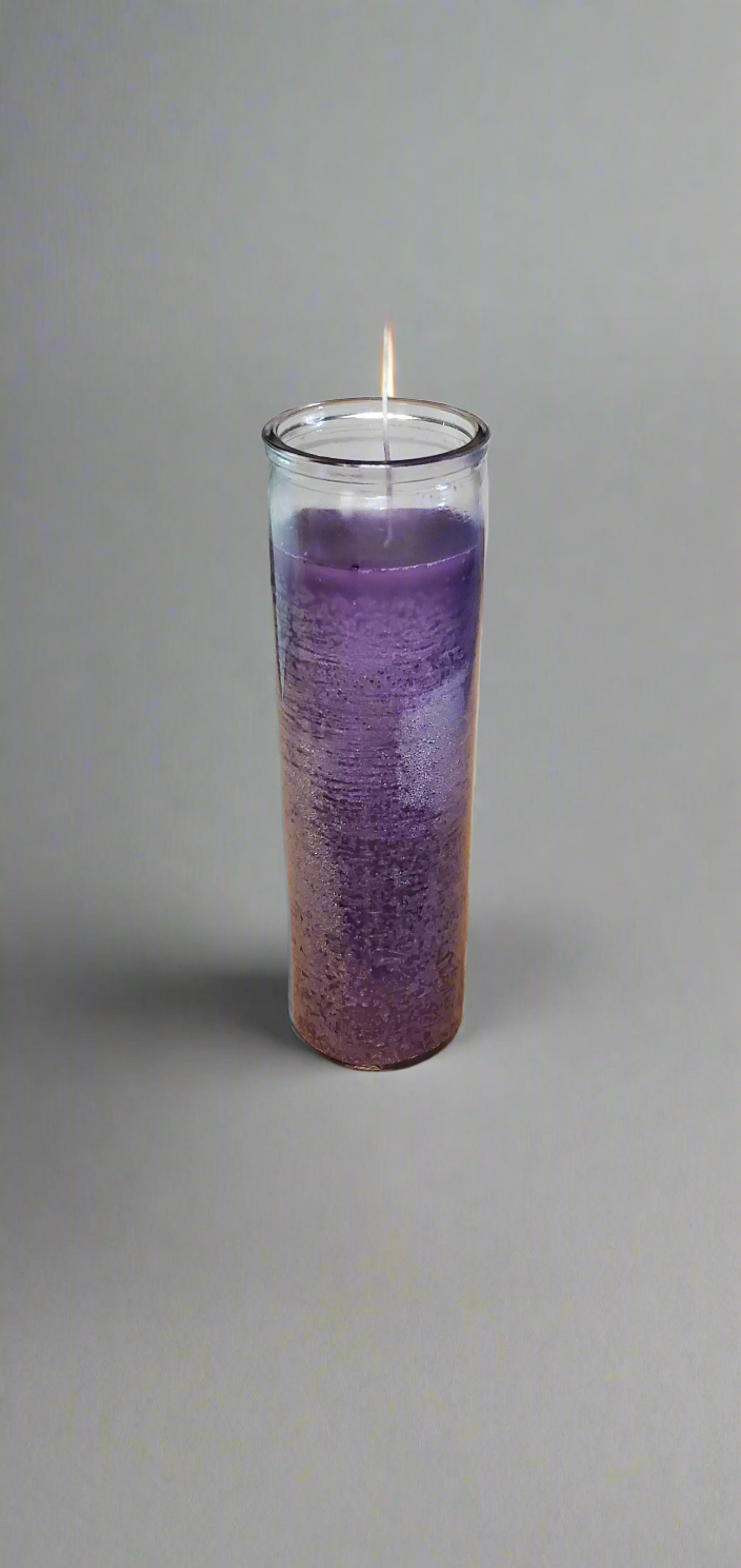 Lit purple 7 Day jar candle in a clear glass container against a plain background.
