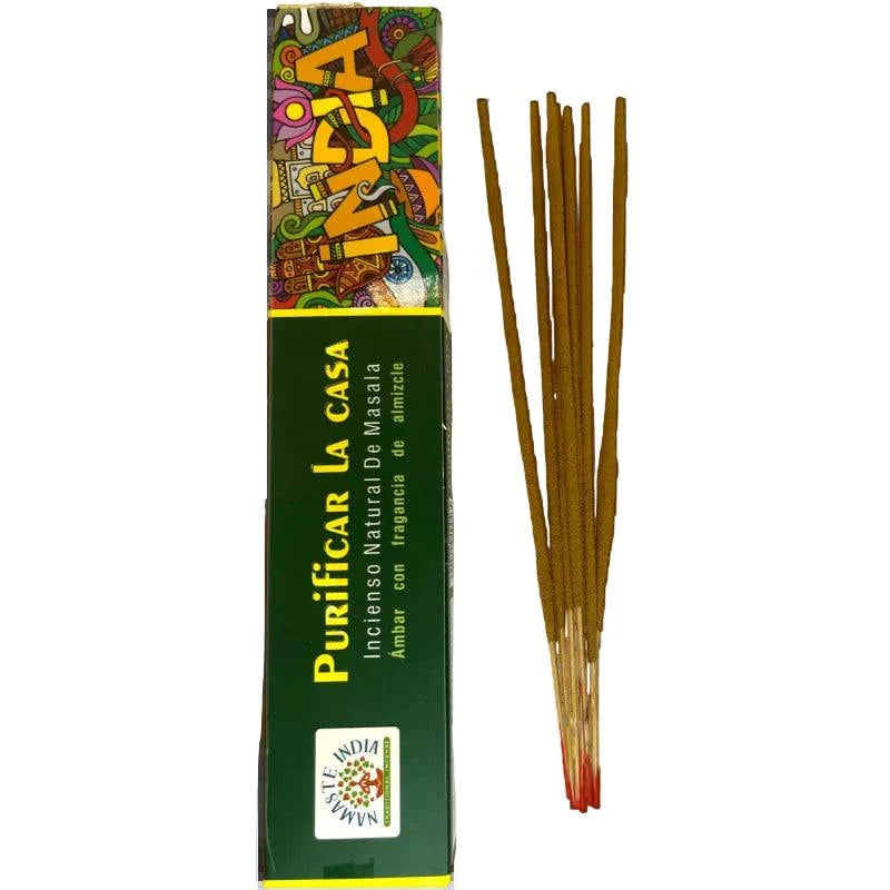 Green box with yellow writing and next to incense sticks on clear background