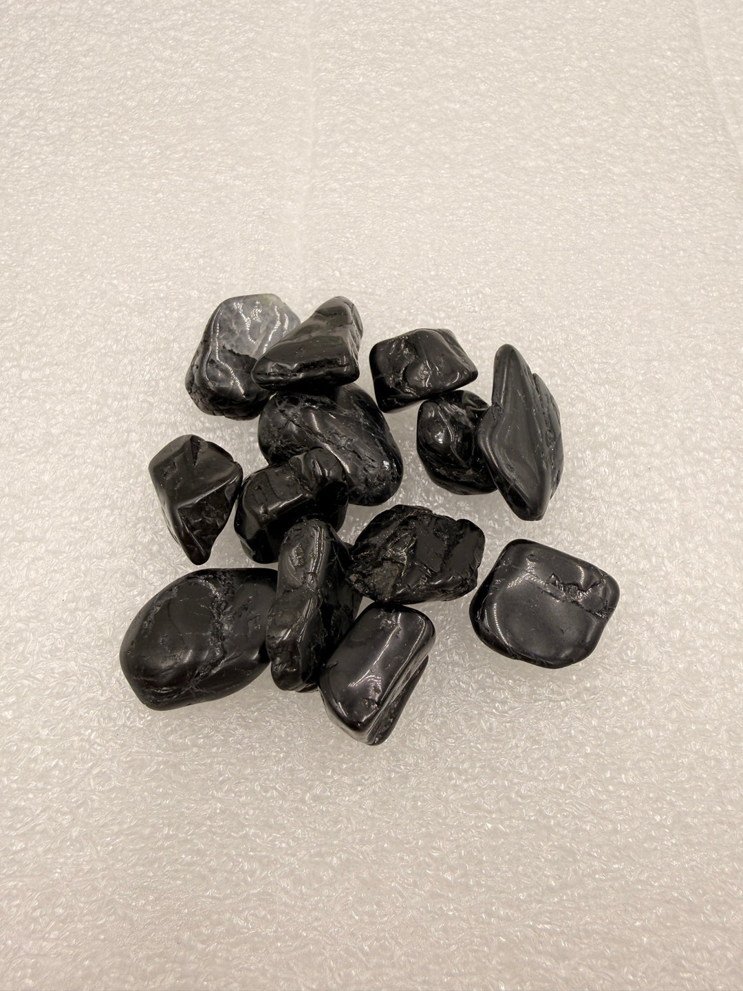 Black tourmaline tumbled pocket stones, group