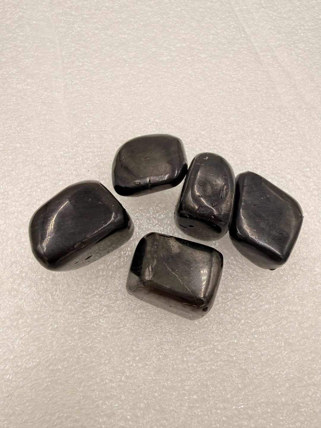 Shungite tumbled stones, group of five