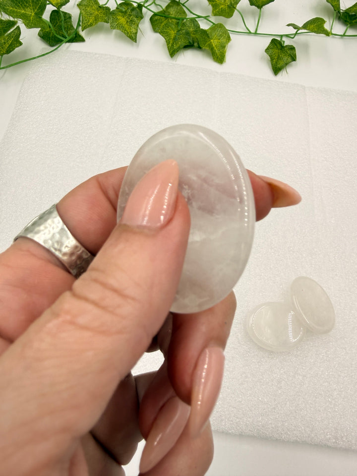 Clear quartz comfort stone held between fingers
