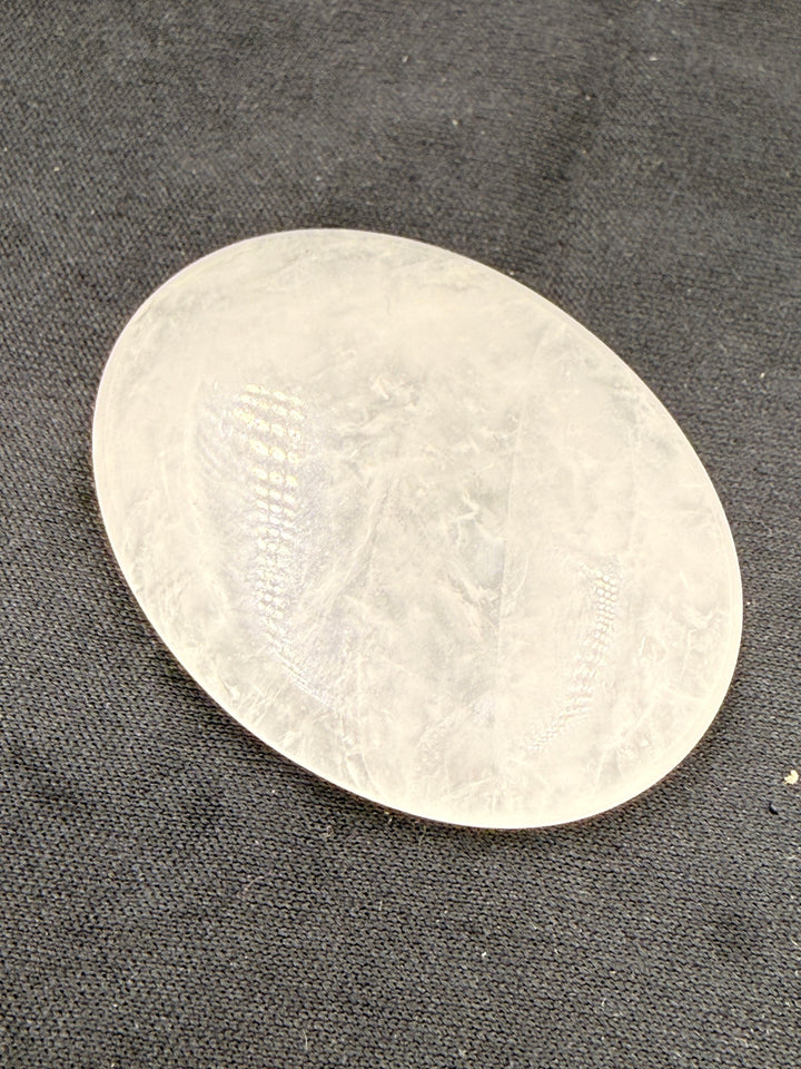 Clear quartz comfort stone on dark cloth