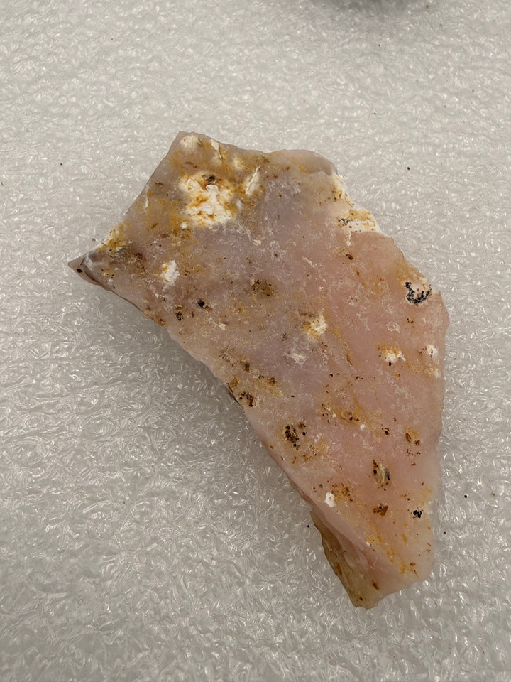 Cherry opal rough pocket stone showing pink opal veins